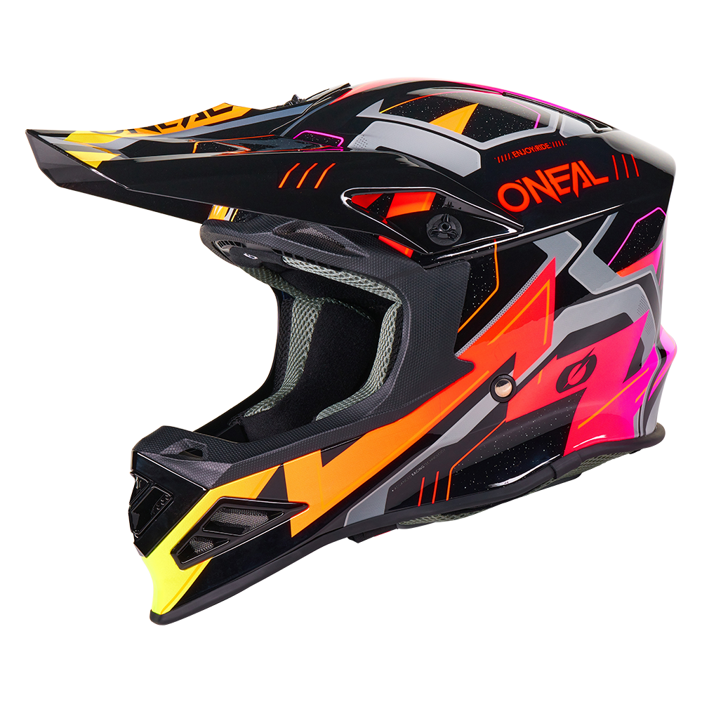 Le casque O'NEAL F-SRS CRUX a une coque noire avec des graphiques anguleux orange fluo, roses, jaunes et gris, une grande visière et l'inscription "O'NEAL" en orange sur le côté.