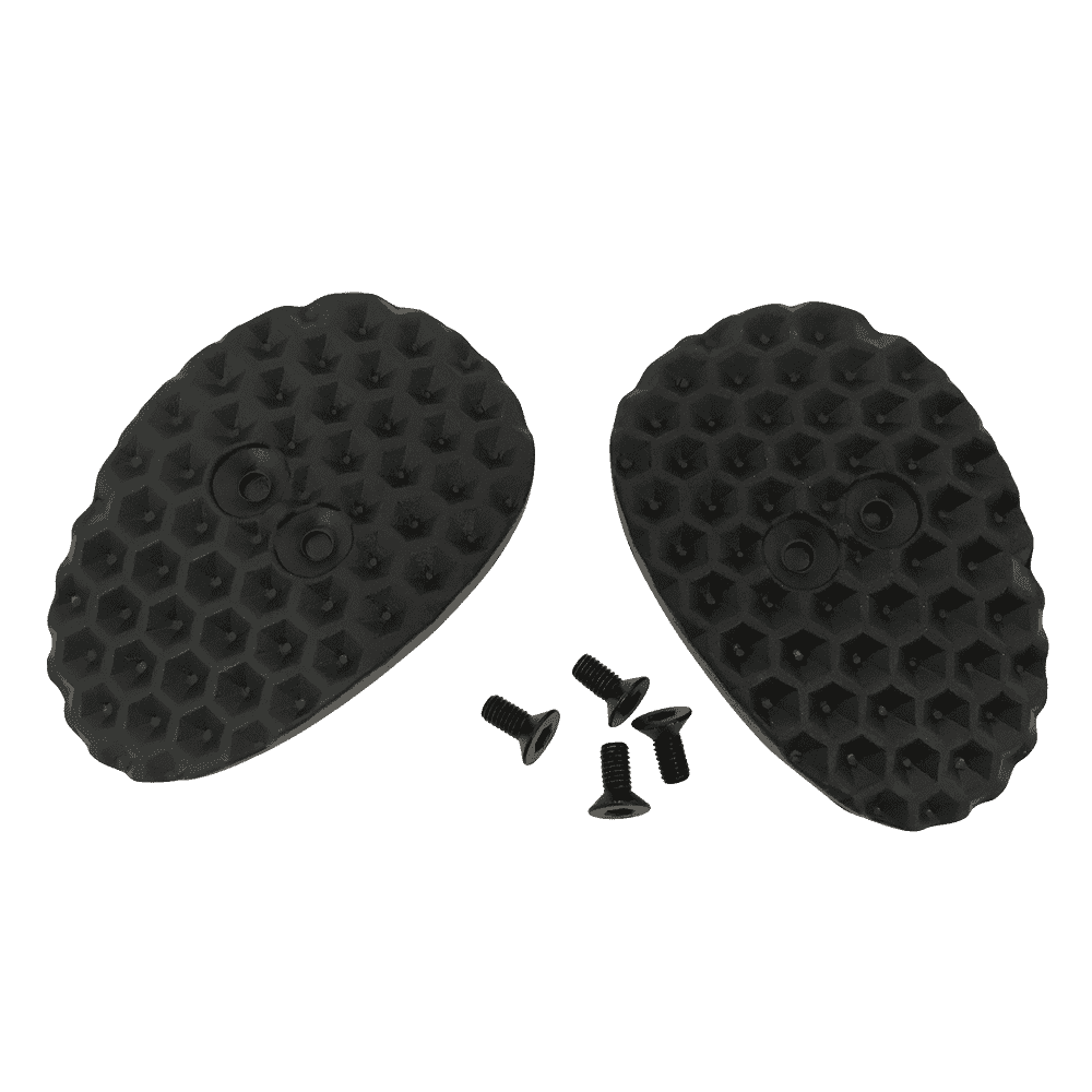 El Juego de Cubrecalas O'NEAL para zapatillas SPD consta de dos tapas ovaladas, negras y texturizadas, con un dibujo de panal de abeja, y cuatro pequeños tornillos negros, todo ello sobre un fondo monocolor.