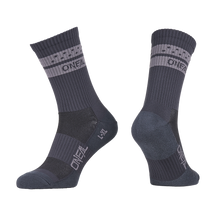 A pair of O'NEAL MTB Performance socks SOLID in gray with light gray bands and "O'NEAL" lettering on the cuff and foot, shown from the side and at an angle to show both the front and back.