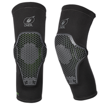 Two black O'NEAL FLOW knee pads with honeycomb shells and green accents stand upright and feature front and angled views against a solid color action sports background.