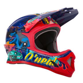 El Casco O'NEAL Sonus Kids Rex es un casco de BTT colorido con un vibrante arte de graffiti, que incluye un dinosaurio azul, gafas de sol, palmeras, un coche, una Mujer en bikini y las llamativas letras "O'NEAL" en el lateral.