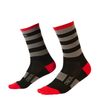A pair of black O'NEAL MTB Performance socks STRIPE crew socks with gray stripes, red heels, toes and cuffs and the O'NEAL logo in white on the toes and ankle.