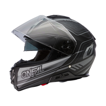 Der O'NEAL M-SRS Helm STRING ist ein schwarz-grauer Integralhelm mit klarem Visier, der mit dem O'NEAL-Logo und stilvollen M-SRS-Grafiken an den Seiten versehen ist.