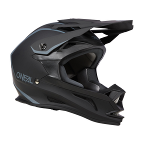 Il casco O'NEAL Drop DH Solid è un casco da motocross integrale nero e grigio con visiera, design aerodinamico e molteplici aperture di ventilazione. Il marchio "O'NEAL" è ben visibile sul lato. Questo casco combina sicurezza e comfort grazie agli interni imbottiti per una maggiore protezione.
