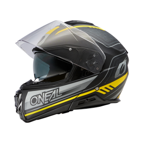 Der O'NEAL M-SRS Helm STRING, ein schwarz-grauer Motorradhelm mit gelben Details und einem durchsichtigen Visier mit dem M-SRS-Logo, wird vor einem schwarzen Hintergrund gezeigt.