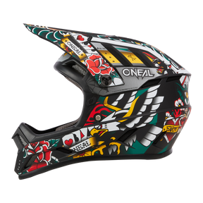 The O'NEAL BACKFLIP helmet Inked is a black full-face MTB helmet with roses, hearts, dice, an eagle and tattoo-style banners. The O'NEAL logo is located on the side - ideal for mountain biking or motocross.