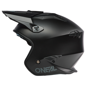 The O'NEAL VOLT helmet SOLID is a matte black full-face motocross helmet with angular ventilation openings and a visor that is depicted in the side profile on a white background and reflects the typical style of the O'NEAL brand.