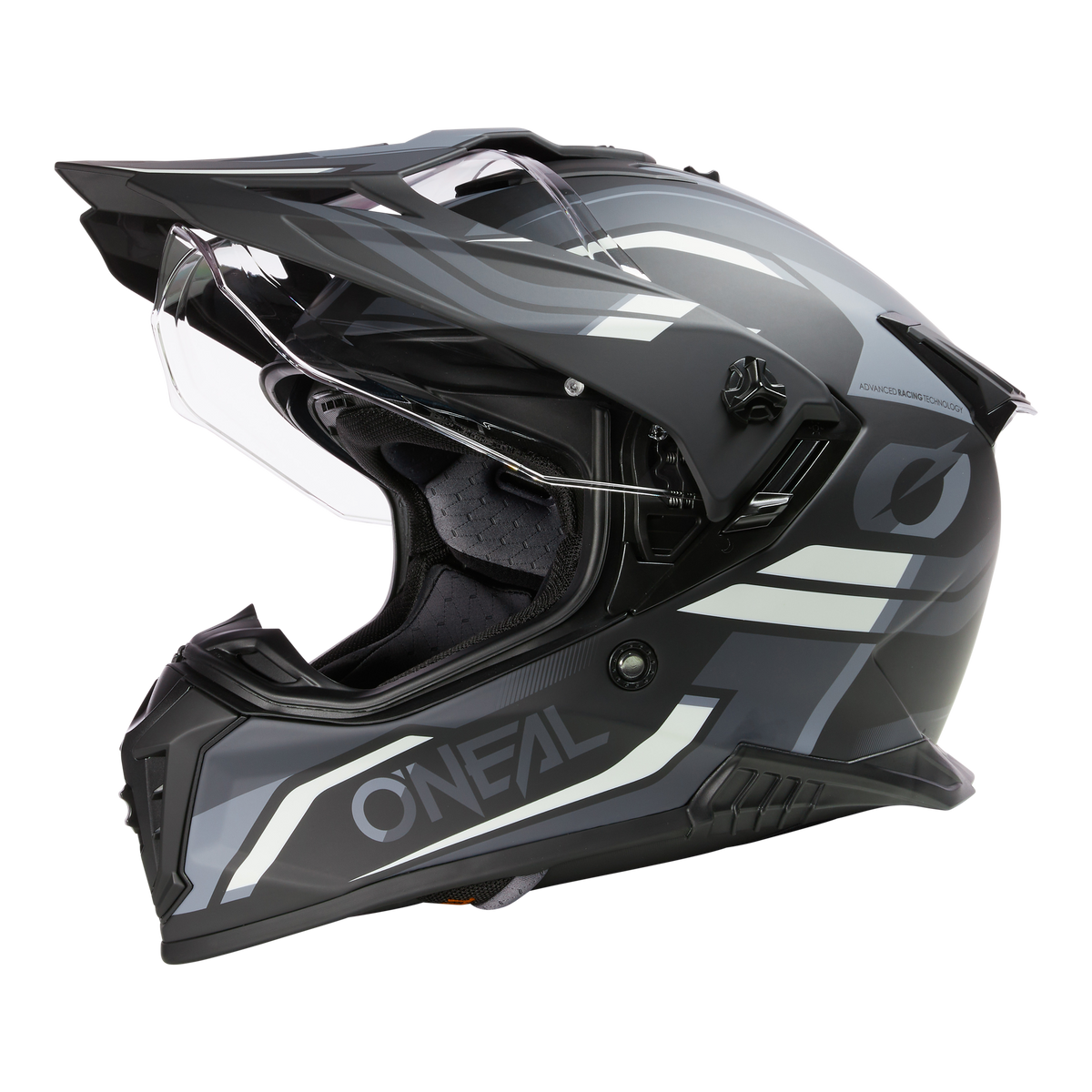 Der O'NEAL A-SRS Helm SPIKE ist ein schwarz-grauer Motocross-Vollvisierhelm mit weißen Grafikakzenten, klarem Visier und kantigem Design auf schwarzem Hintergrund.