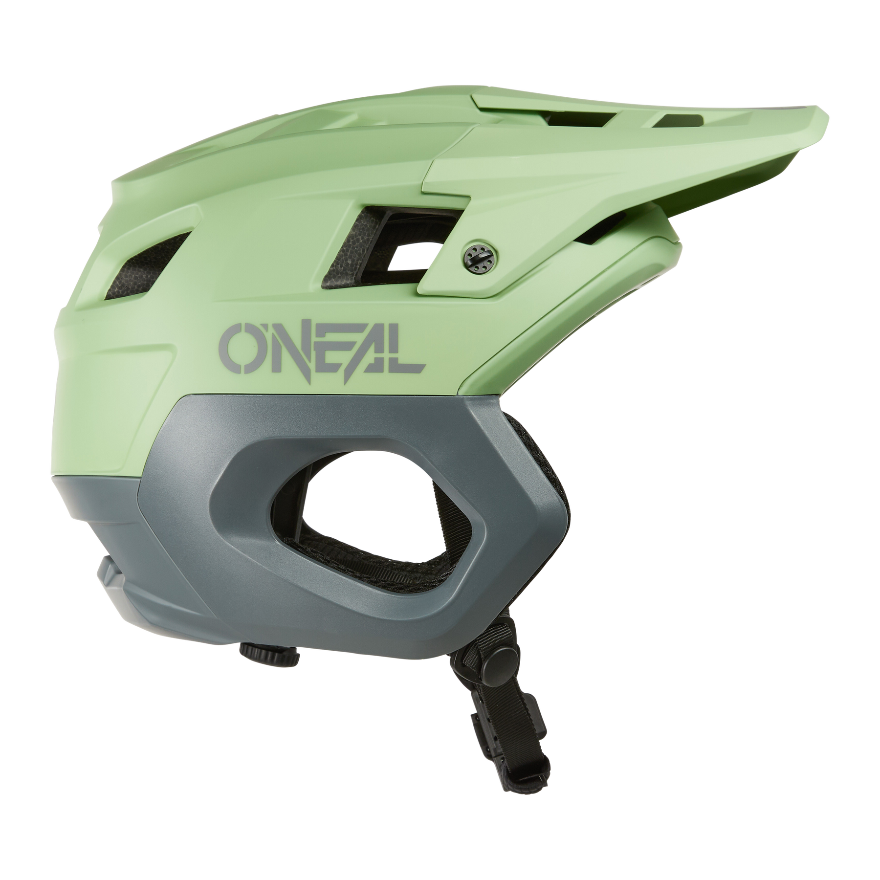 Le casque O'NEAL TRAPPER Helmet SOLID est un casque de mountainbike vert clair et gris avec visière, trous d'aération et jugulaire réglable, représenté de profil sur fond blanc.