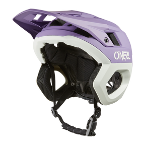 A purple and white O'NEAL TRAPPER helmet SOLID with extended visor, ventilation slits, black inner padding and adjustable chin strap.