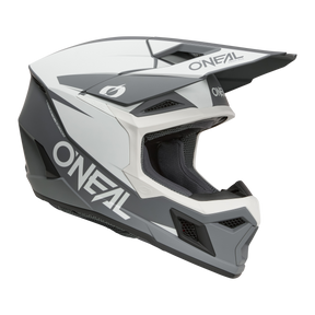 Il casco O'NEAL 3SRS Solid è un casco da motocross integrale di colore bianco, grigio e nero con un'ampia visiera, aperture di ventilazione e il marchio O'NEAL sul lato.