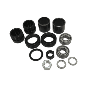 AZONIC Central Axle Instruction Combo Set I componenti del pedale Americana, tra cui parti cilindriche nere, cuscinetti metallici, dadi esagonali e rondelle, sono disposti su uno sfondo a tinta unita.