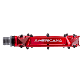 Un pedal AZÓNICO AMERICANO rojo con alfileres negros y "AMERICANA" en letras blancas en el lateral, sobre fondo negro.