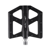 A black, flat AZONIC KAMIKAZE bicycle pedal with a wide platform, metallic grip knobs and a silver axle, displayed on a transparent background. The lettering "AZONIC" in white is located in the center of the pedal.