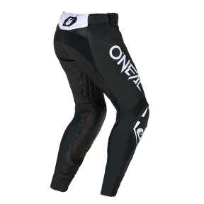 O'NEAL HARDWEAR Pants ELITE en noir avec l'inscription blanche "O'NEAL", genoux rembourrés et zones renforcées, représentées de derrière et de côté.